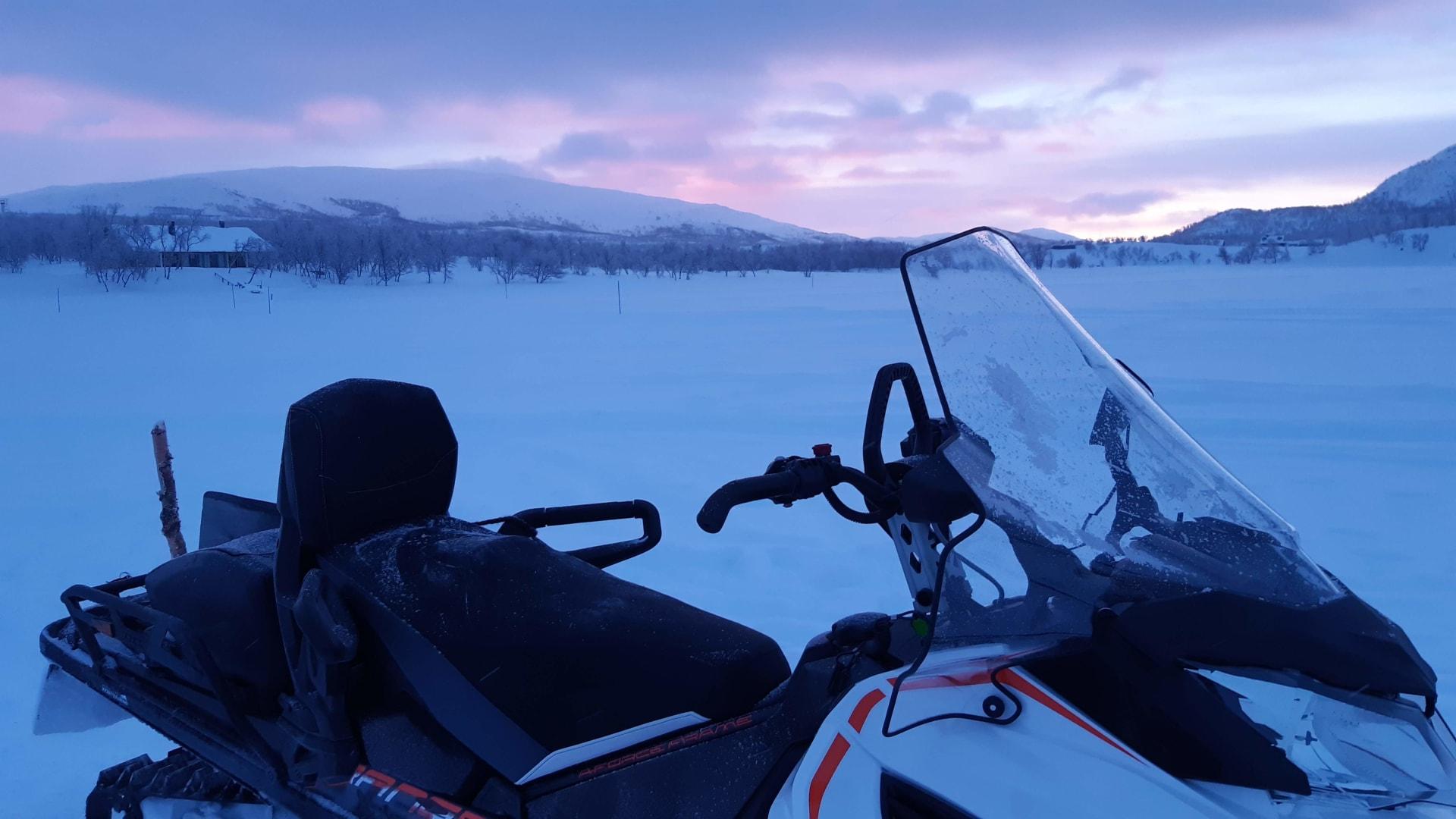 Snowmobile on the frozen lake waiting for you.